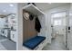 Entryway/mudroom featuring a built-in bench with storage, coat hooks, and access to the laundry room at 8901 Dio Guardi Dr, Las Vegas, NV 89117