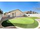 Expansive backyard featuring a putting green, patio, and privacy fence, perfect for entertaining at 8936 Medicine Wheel Ave, Las Vegas, NV 89143