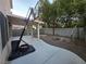 View of a backyard with patio, block wall, desert landscaping, and mature trees at 9662 Allison Ranch Ave, Las Vegas, NV 89148