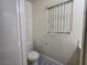 Powder room featuring a toilet, window with blinds, and accessories at 9662 Allison Ranch Ave, Las Vegas, NV 89148