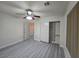 Bedroom with closet and ceiling fan. Neutral walls and gray laminate flooring at 9662 Allison Ranch Ave, Las Vegas, NV 89148