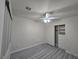 Bedroom with ceiling fan, closet with built-in shelving, neutral walls, and gray laminate flooring at 9662 Allison Ranch Ave, Las Vegas, NV 89148