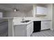 Modern kitchen featuring a sink, dishwasher, and bar seating, open to the living area at 9662 Allison Ranch Ave, Las Vegas, NV 89148