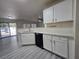 Well-lit kitchen featuring white cabinets, light countertops, and modern black dishwasher appliance at 9662 Allison Ranch Ave, Las Vegas, NV 89148