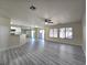 Bright and airy living room featuring wood-look flooring and sliding doors to the patio at 9662 Allison Ranch Ave, Las Vegas, NV 89148