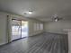 Spacious living room with modern wood-look floors, ceiling fan, and natural light at 9662 Allison Ranch Ave, Las Vegas, NV 89148