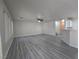 Bright open-concept living room featuring plank flooring, neutral paint, and abundant natural light at 9662 Allison Ranch Ave, Las Vegas, NV 89148