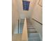 Bright staircase leading to the second floor, featuring gray wood-look flooring at 9662 Allison Ranch Ave, Las Vegas, NV 89148