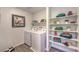 Well-organized laundry room with washer, dryer, and ample shelving for storage and decor at 9932 Ullom Dr # 5, Las Vegas, NV 89141
