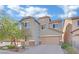 Attractive two-story home featuring a two-car garage, neutral stucco, and a well-manicured front yard at , Las Vegas, NV 89131