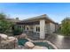 Backyard view featuring a unique pool and spa with a waterfall feature, and a covered patio area at 10 Greely Club Trl, Henderson, NV 89052