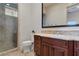 Bathroom featuring a glass shower and wooden vanity with a large framed mirror at 10 Greely Club Trl, Henderson, NV 89052