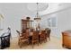 Formal dining room with elegant lighting, a tray ceiling, and traditional furniture at 10 Greely Club Trl, Henderson, NV 89052