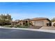 Charming single story home with a manicured lawn, mature landscaping, and a welcoming two-car garage at 10 Greely Club Trl, Henderson, NV 89052