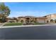 Charming single story home with a manicured lawn, mature landscaping, and a welcoming two-car garage at 10 Greely Club Trl, Henderson, NV 89052
