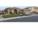 Charming single story home with a manicured lawn, mature landscaping, and a welcoming two-car garage at 10 Greely Club Trl, Henderson, NV 89052