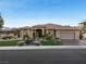 Charming single-story home featuring manicured front lawn and a three car garage at 10 Greely Club Trl, Henderson, NV 89052
