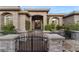 Stunning stone home featuring a gated entrance and meticulous landscaping, creating a welcoming curb appeal at 10 Greely Club Trl, Henderson, NV 89052