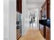 Hallway with granite counters, wood cabinets, and stainless steel refrigerator at 10 Greely Club Trl, Henderson, NV 89052