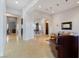 Open-concept living room with tile floors, recessed lighting, neutral walls and doors leading to other rooms at 10 Greely Club Trl, Henderson, NV 89052