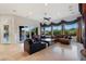 Spacious living room with tile floors, large windows, patio doors, and comfortable seating at 10 Greely Club Trl, Henderson, NV 89052