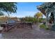 Outdoor kitchen featuring a grill and countertop space, surrounded by mature landscaping at 10 Greely Club Trl, Henderson, NV 89052