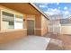 Back entrance of home showing gravel landscaping, and a covered patio at 1009 Fishing St, Henderson, NV 89011