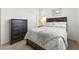 Cozy bedroom featuring a bed, dresser, and carpet flooring at 1009 Fishing St, Henderson, NV 89011