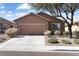 Traditional single-Gathering home with a two-car garage and desert landscaping at 1009 Fishing St, Henderson, NV 89011