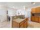 Spacious kitchen with granite countertops, stainless sink, and eat-in breakfast bar for casual dining at 1009 Fishing St, Henderson, NV 89011
