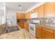 Well-equipped kitchen with wood cabinets, granite countertops, tile backsplash, and stainless steel sink at 1009 Fishing St, Henderson, NV 89011