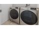 Modern laundry room features side-by-side Samsung washer and dryer units at 1009 Fishing St, Henderson, NV 89011