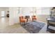Cozy living room featuring tile floors, an area rug, two chairs, and access to an exterior door at 1009 Fishing St, Henderson, NV 89011