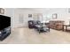 Bright living room with neutral tile floors, large windows, and comfy sofas perfect for relaxation at 1009 Fishing St, Henderson, NV 89011