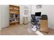 Carpeted home office featuring a bookshelf, desk, chair and window at 1009 Fishing St, Henderson, NV 89011