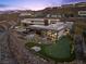 Aerial view of luxury home featuring a backyard putting green and a modern pool at 11 Cloud Chaser Blvd, Henderson, NV 89012