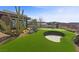 Home's backyard features a putting green, sand trap and desert landscaping at 11 Cloud Chaser Blvd, Henderson, NV 89012