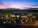 Dusk aerial view of luxury home with modern landscaping and city lights in the background at 11 Cloud Chaser Blvd, Henderson, NV 89012