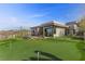 Contemporary home with a putting green, desert landscaping, and modern architecture at 11 Cloud Chaser Blvd, Henderson, NV 89012