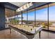 Pool table in game room with floor to ceiling windows offers picturesque views at 11 Cloud Chaser Blvd, Henderson, NV 89012