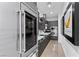 Modern kitchen featuring stainless steel appliances, sleek cabinetry, and unique banana artwork at 11 Cloud Chaser Blvd, Henderson, NV 89012