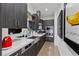 Modern kitchen featuring sleek cabinetry, stainless steel appliances, and a mirrored backsplash at 11 Cloud Chaser Blvd, Henderson, NV 89012