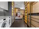 Large laundry room with washer and dryer, closet system, and custom shelving at 11 Cloud Chaser Blvd, Henderson, NV 89012