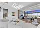 Spacious living area with contemporary design, fireplace, and stunning city views at 11 Cloud Chaser Blvd, Henderson, NV 89012