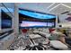Open-concept living room featuring a modern fireplace, expansive windows with a stunning view, and stylish decor at 11 Cloud Chaser Blvd, Henderson, NV 89012
