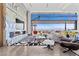 Open-concept living space with floor-to-ceiling windows, offering stunning views and modern furnishings at 11 Cloud Chaser Blvd, Henderson, NV 89012