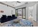 Bright living room offers modern furnishings, large sliding glass doors, and view of outdoor patio at 11 Cloud Chaser Blvd, Henderson, NV 89012