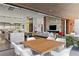 Open-concept outdoor space with a dining table, a modern kitchen and a fireplace at 11 Cloud Chaser Blvd, Henderson, NV 89012