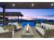 Relaxing outdoor patio area with comfortable seating, a modern fireplace, and stunning views of the city at 11 Cloud Chaser Blvd, Henderson, NV 89012