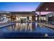 An infinity pool surrounded by desert landscaping offering comfortable lounge chairs at 11 Cloud Chaser Blvd, Henderson, NV 89012